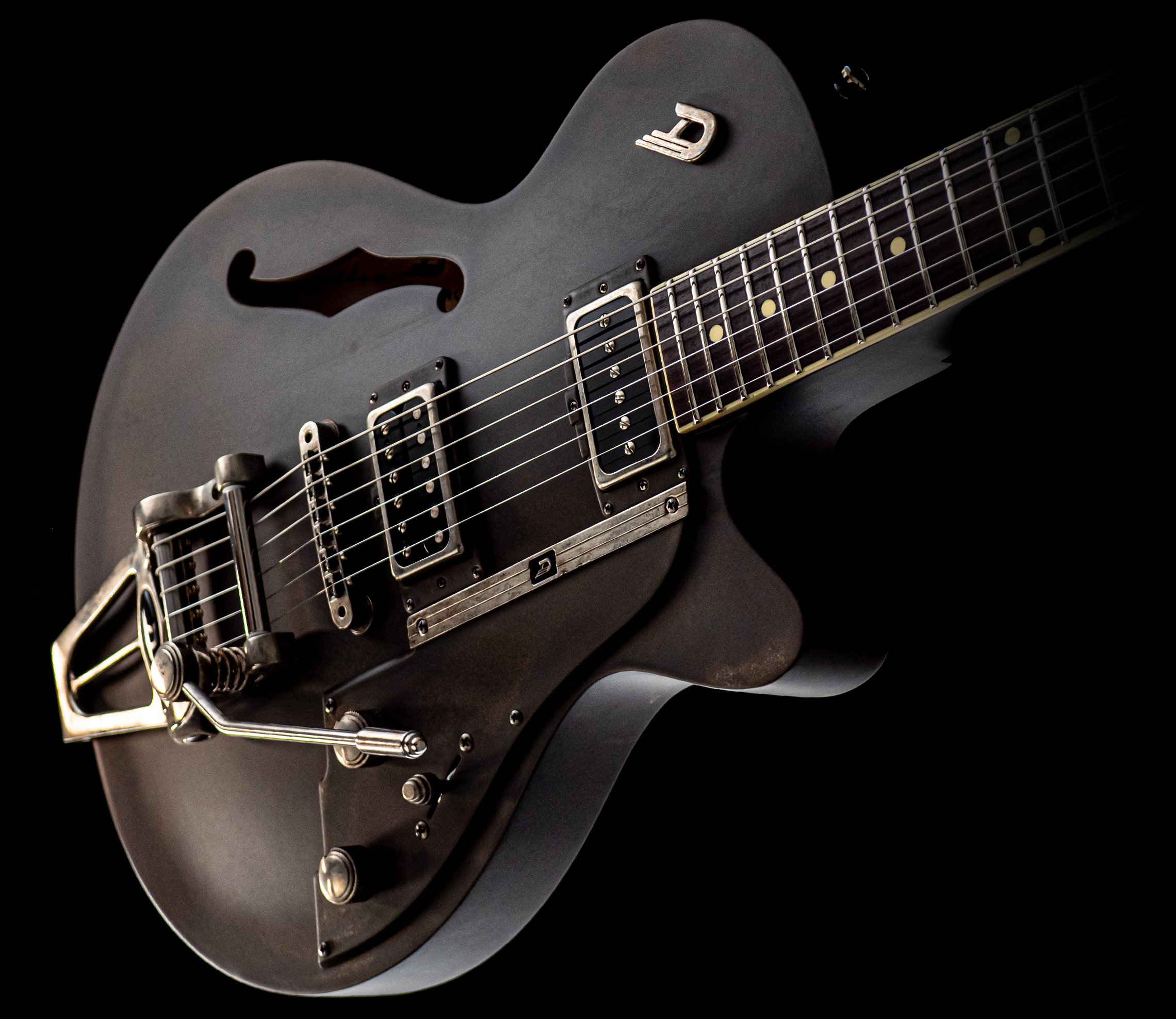 Angled view of the body of the Duesenberg Custom Shop Rusty Steel on a dark background